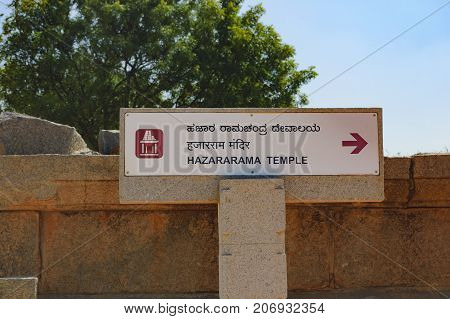 Hampi, India - November 20, 2012: Signpost for tourists with the pointer to Hazara Rama Temple in Hampi, Karnataka, India.