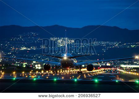 OSAKA, JAPAN - Aug. 14, 2017: Boeing airplane taking off from the Itami International Airport in Osaka, Japan in the night.