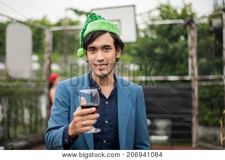 Young People Holding Glass Talk In The Party.