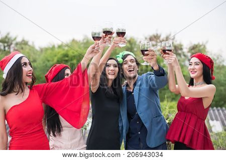 Young People Holding Glass Talk In The Party.