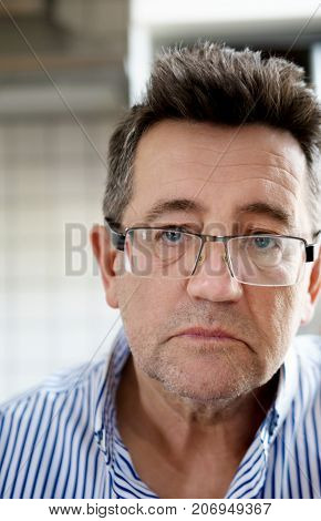 Close up portrait of senior man at home.