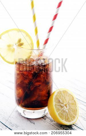 Softdrink With Ice Cubes, Lemon And Straw In Glass