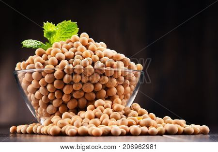 Composition With Bowl Of Soya Beans On Wooden Table