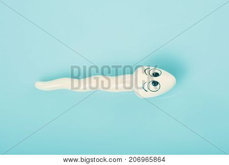 Two sperms (object) compete on blue background