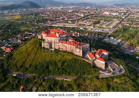 Aerial view of the Majestic Fortress - Palanok Castle towering above the city of Mukacheve, Ukraine.