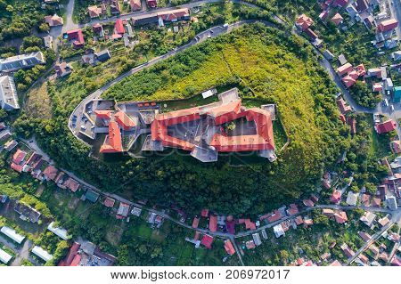 Aerial view of the Majestic Fortress - Palanok Castle towering above the city of Mukacheve, Ukraine. Top view, from above