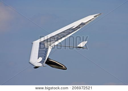 Hang glider flying in a blue sky