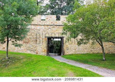 Open gate to the park in medieval defensive wall stone wall. The Hungry Wall on the Petrin Hill
