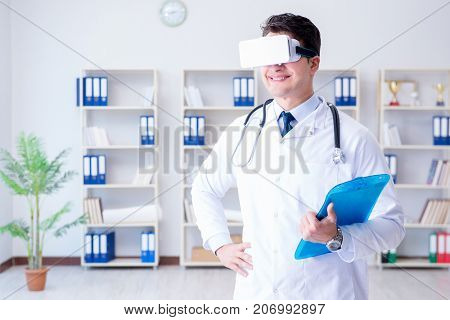 Young doctor with vr virtual reality headset working in the offi