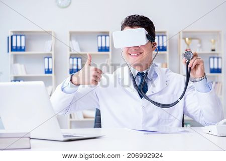 Young doctor with vr virtual reality headset working in the offi