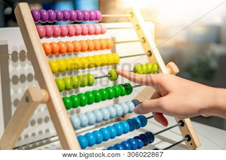 Male Hand Calculating With Beads On Wooden Rainbow Abacus For Number Calculation. Mathematics Learni