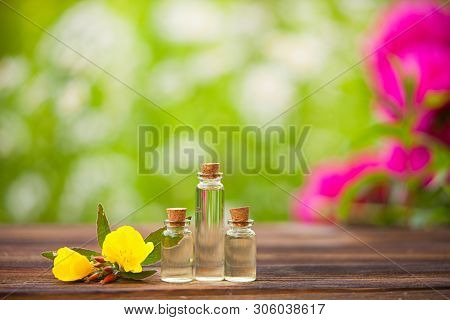 Sundrops Essential Oil In  Beautiful Bottle On Wooden Background