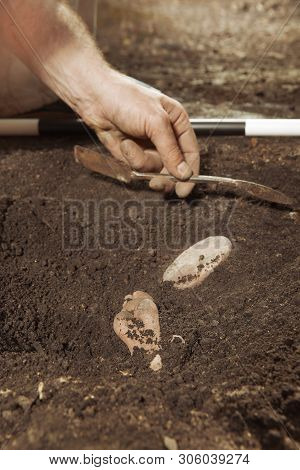 Archeologist On Tropical Location During Find Of Rare Votive Woman Statue
