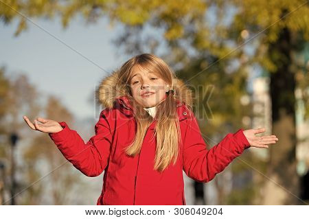 Happy Small Girl In Autumn Park. Small Girl Did It In Mistake. Oops. Even The Wisest Of Us Can Make 