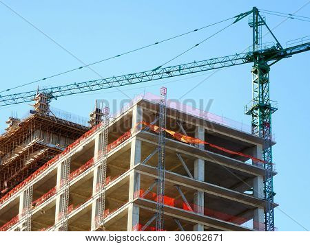 Construction Site Background. Hoisting Cranes And New Multi-storey Buildings. I.ndustrial Background