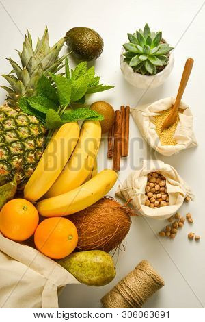 Zero Waste Food Storage. Fruits And Cereals In Eco Textile Bags, White Background. Copy Space. Flat 
