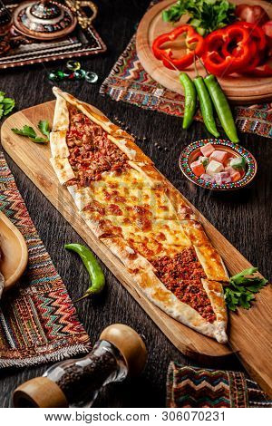 Traditional Turkish Cuisine. Turkish Pizza Pita With A Different Stuffing, Meat, Cheese, Slices Of V