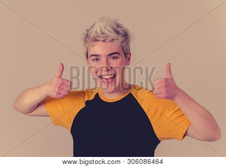 Portrait Of Good Looking Young Trans Teenager Male Showing Thumbs Up Sign Feeling Cheerful Happy And