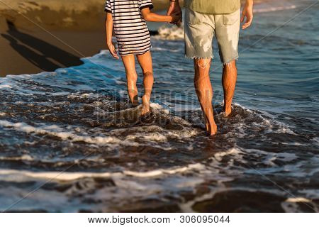 Father And Son, Man & Boy Child, Running And Having Fun In The Sand And Waves Of A Sunny Beach