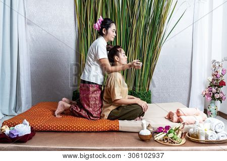Thai Masseuse Doing Massage For Lifestyle Woman In Spa Salon. Asian Beautiful Woman Getting Thai Her