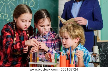 Inspired To Work Hard. Happy Children Teacher. Doing Experiments With Liquids In Chemistry Lab. Chem