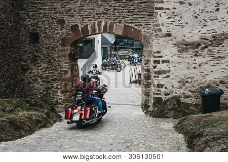 Vianden, Luxembourg - May 18, 2019: Gunfighters Bikers Riding Through A Gate Inside Vianden Castle, 