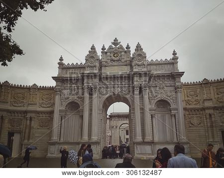 Istanbul, Turkey - September 25, 2018. Tourists At The Main Entrance To The Dolmabahche Palace Compl