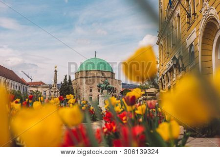 PECS, HUNGARY - MAY 2019: View on people as they pass by on the pedestrian zone in the downtown of the city May 2019 in Pecs, Hungary