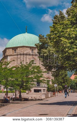 PECS, HUNGARY - MAY 2019: View on people as they pass by on the pedestrian zone in the downtown of the city May 2019 in Pecs, Hungary