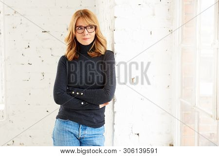Beautiful Smiling Woman Standing With Arms Crossed While Relaxing At The Window