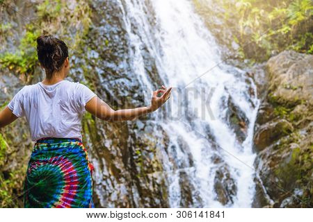 Asian Women Relax In The Holiday. Play If Yoga.  Play If Yoga At Waterfall On The Moutain. Exercise,