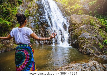 Asian Women Relax In The Holiday. Play If Yoga.  Play If Yoga At Waterfall On The Moutain. Exercise,