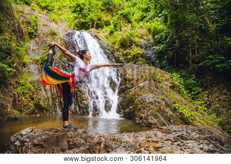 Asian Women Relax In The Holiday. Asian Women Relax In The Holiday. Play If Yoga At Waterfall On The