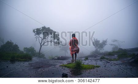 Tourist With Rain Coat Walking Travel Adventure Nature In The Rain Forest At Phu Hin Rong Kla Nation