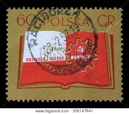 ZAGREB, CROATIA - JULY 03, 2014: a stamp printed in Poland shows Open book and cogwheels, Polish-Soviet friendship, circa 1956.
