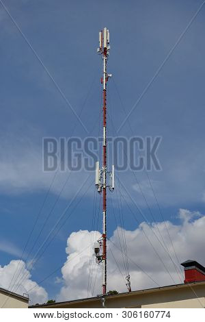 Mobile Telephone Radio Network Antennas On The Building Roof Broadcasting Signal Over The City