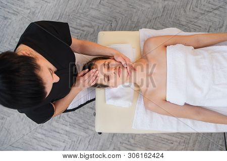 Young Female Masseur Making Massage For Young Client.
