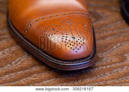 brown brogue toe of men full grain leather shoe, close up