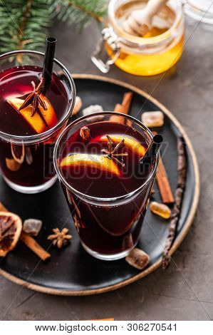Hot Mulled Wine With Spices, Apple And Orange On Chrictmas Background. Copy Space.