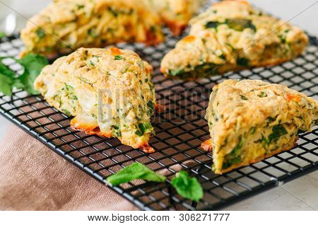 Savory Scones With Feta  Mozarella And Green Herbs On A Wooden Board.