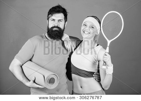 Sporty Couple Training With Fitness Mat And Tennis Racket. Sport Equipment. Athletic Success. Happy 