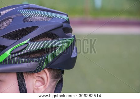 The Back Of A Protective Bicycle Helmet On A Childs Head