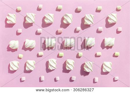 Sweet Beze, White Marshmallows On Pink Background. Pastel Color Dessert. Top View, Flat Lay.