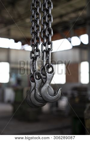 Factory Overhead Crane. Black Steel Chain And Hooks