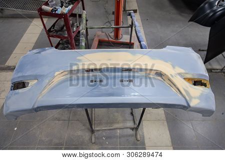 Repair Of The Rear Bumper Of A Blue Car After An Accident With The Help Of Multi-colored Putty In A 