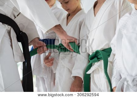 Aikido Trainer Tying Belt For His Pupil Before Competition