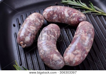 Raw Meat Sausages In A Natural Shell In A Griddle Pan Prepared For Cooking
