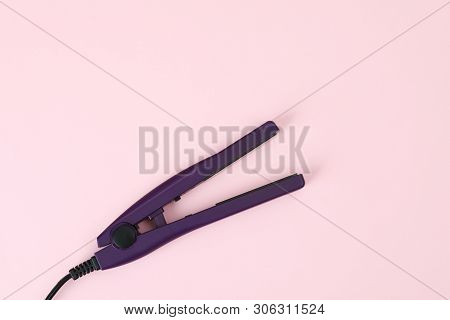 Modern Hair Iron For Straightening On Color Background, Top View