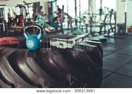 Equipment For Functional Training. Large Rubber Wheel, Hammer, Kettlebell Closeup In The Gym. Cross 