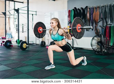 Sport Woman Doing Exersices In Gym With Burbell